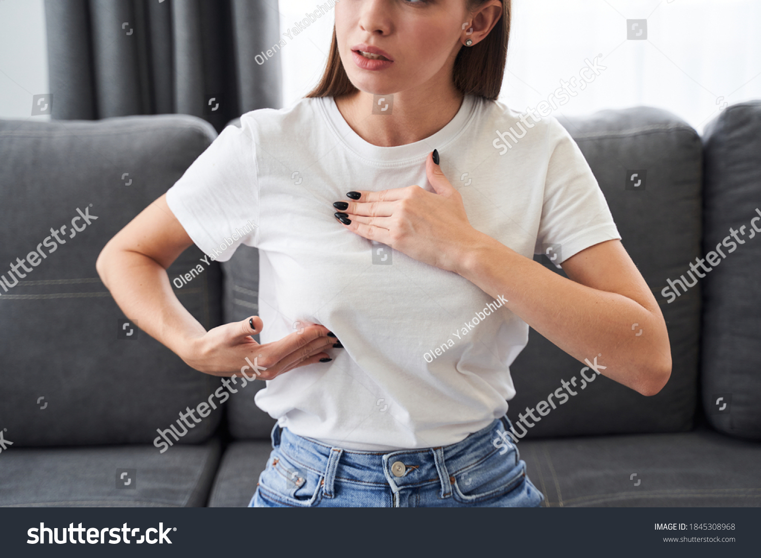 Worried caucasian woman carefully looking and checking breast by herself that she concern about breast cancer. Breast cancer concept #1845308968