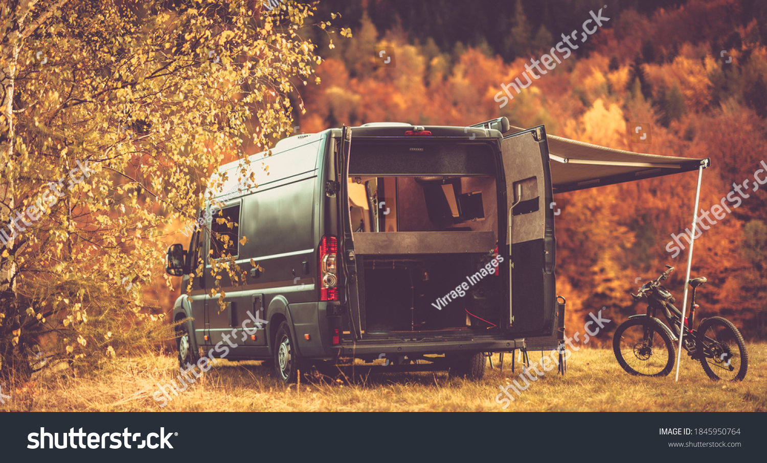 Scenic Recreational Vehicle RV Camping Spot with Fall Foliage Scenery. Class B Motorhome Boondocking in the Remote Place. Outdoor and Recreation Theme. #1845950764