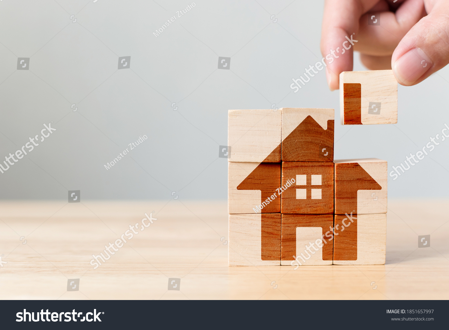 Property investment and house mortgage financial real estate concept. Wooden cube block puzzle with home image #1851657997