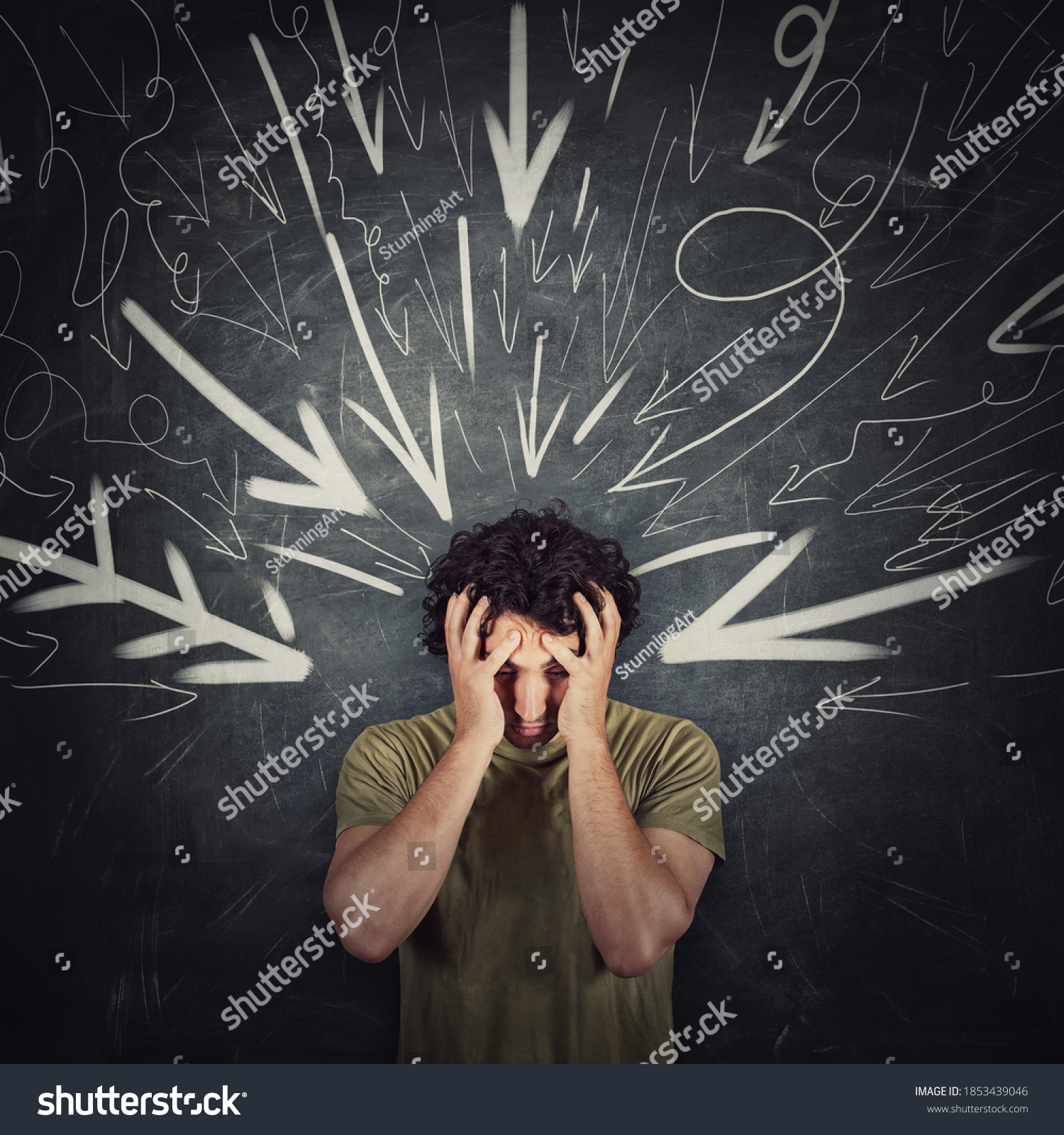 Disappointed guy covers face with his hands, looking down introverted and depressed, being under pressure as multiple arrows points tension negativity to his head. Person suffering emotional breakdown #1853439046