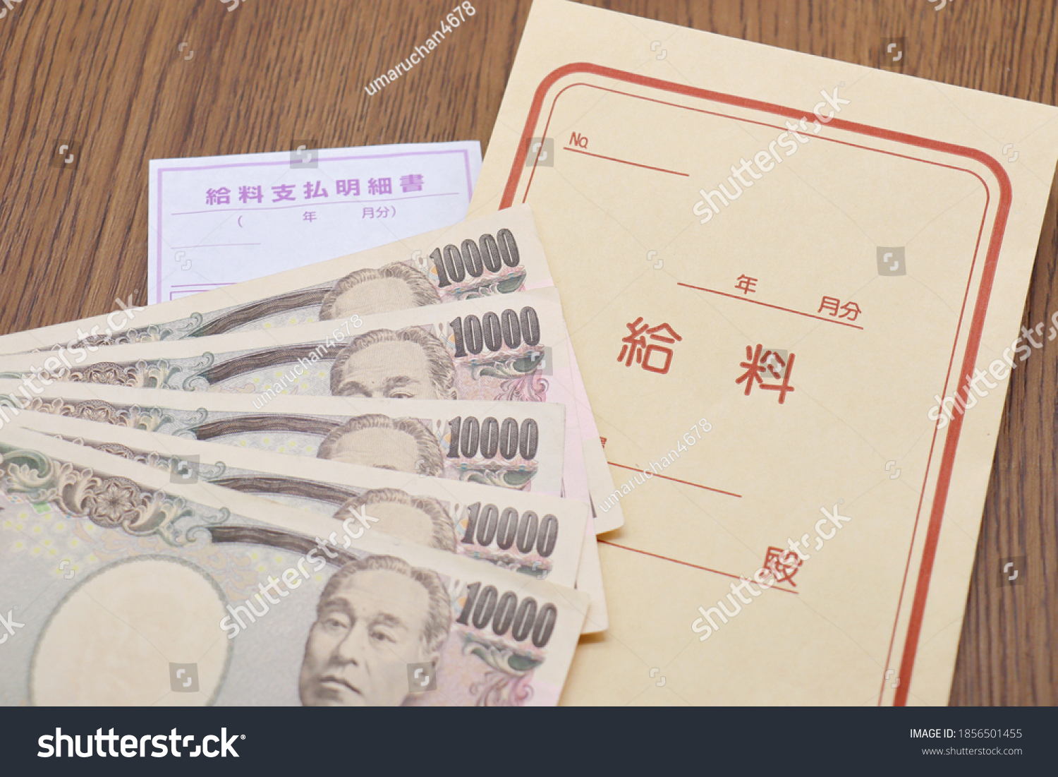 Japanese salary bag and 10,000 yen bill. Translation: Year, Month, Salary, Dear, Pay slip, Year, Month. #1856501455