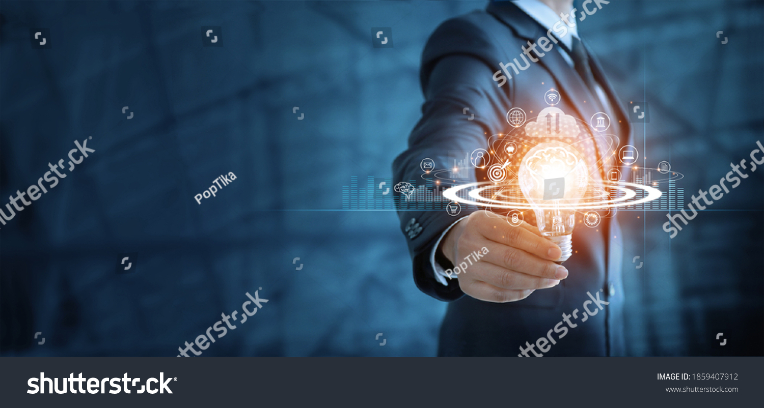 Businessman holding lightbulb and brain with network of business,  Modern executive management’s positive attitude, Growth mindset and developed new era in organization. #1859407912