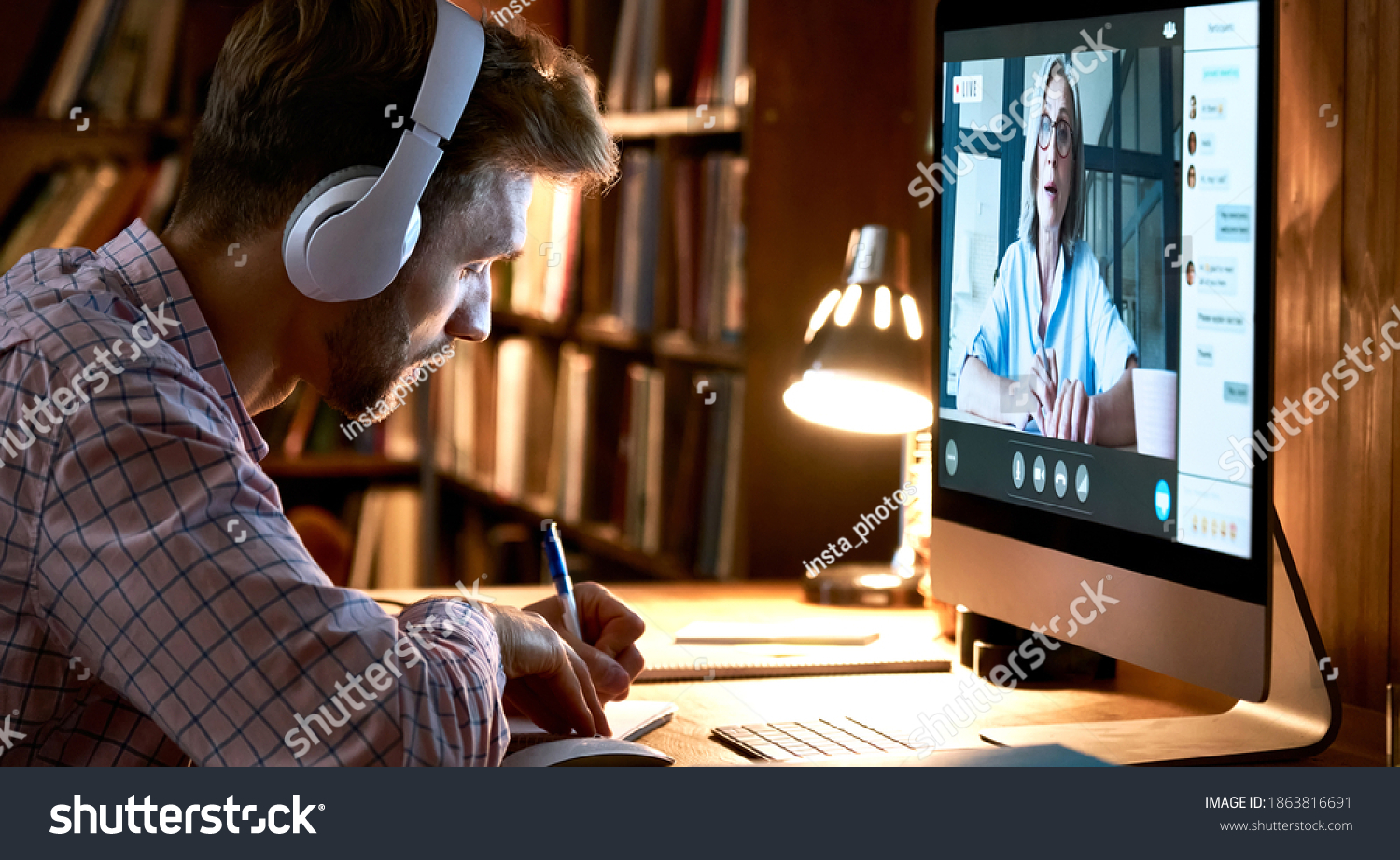 Male student wearing headphones conference video calling, watching webinar, online training class, virtual chat meeting with remote teacher or coach distance learning using computer, taking notes. #1863816691