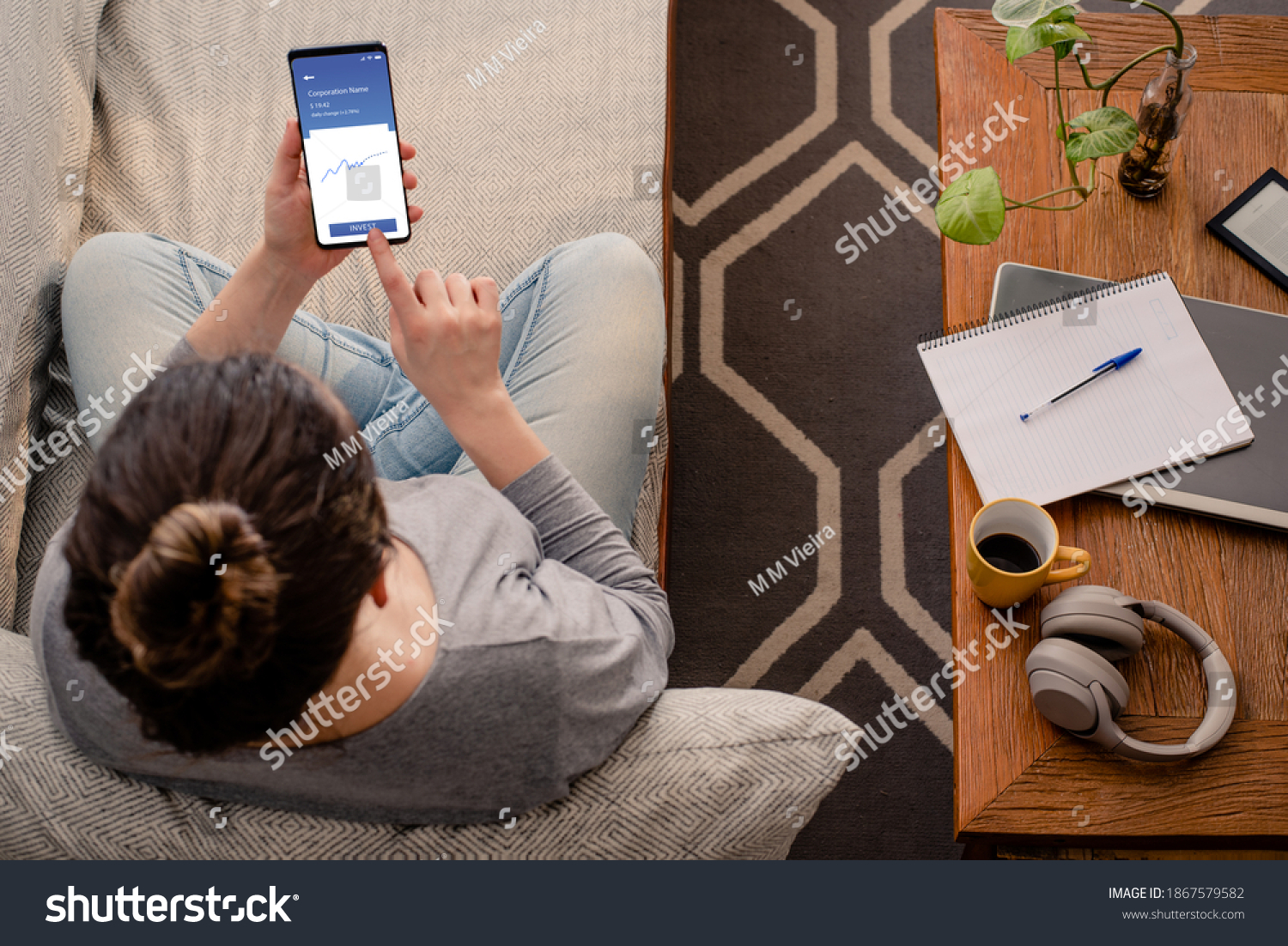 Woman using investment mobile app #1867579582