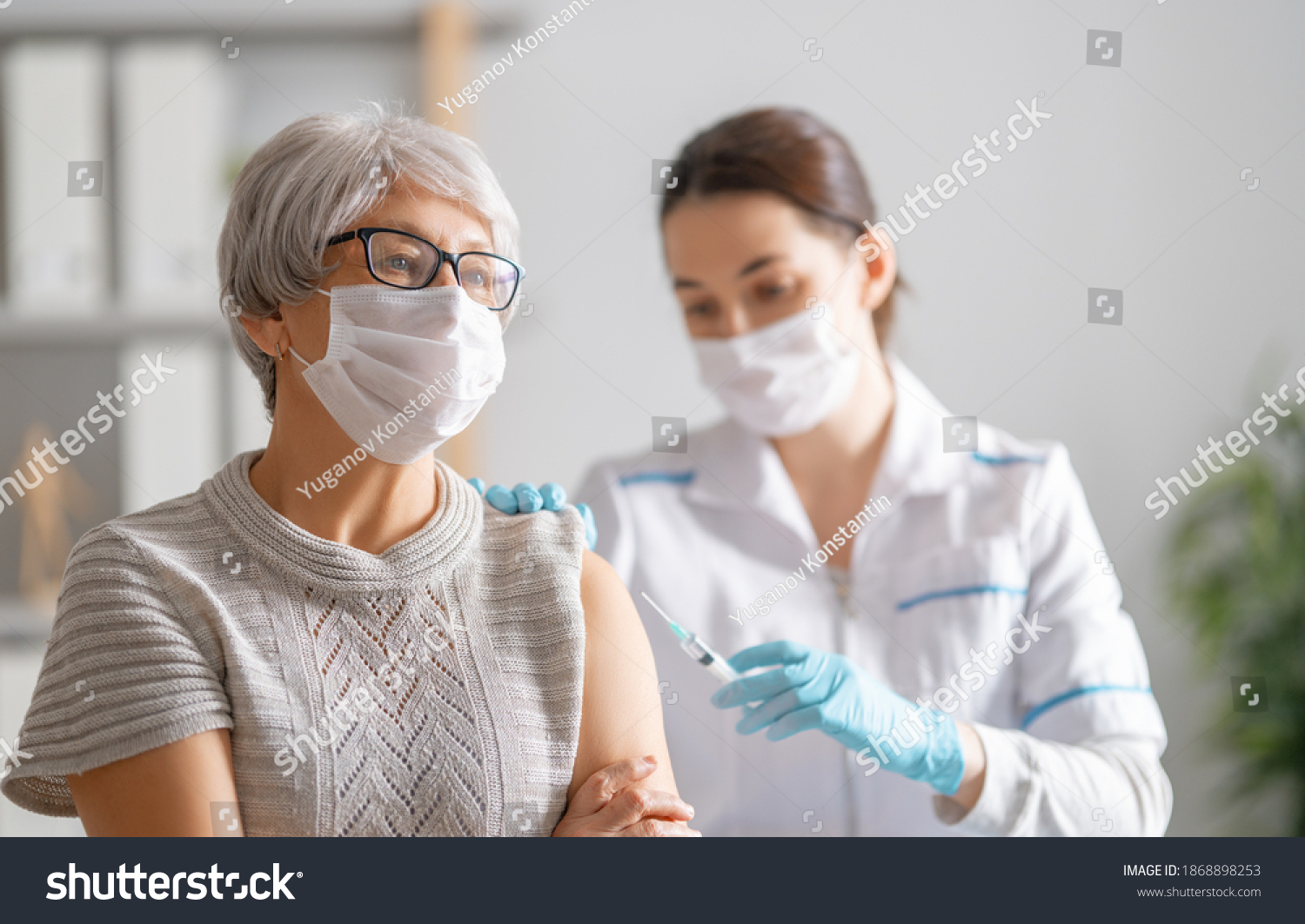 Doctor giving a senior woman a vaccination. Virus protection. COVID-2019. #1868898253