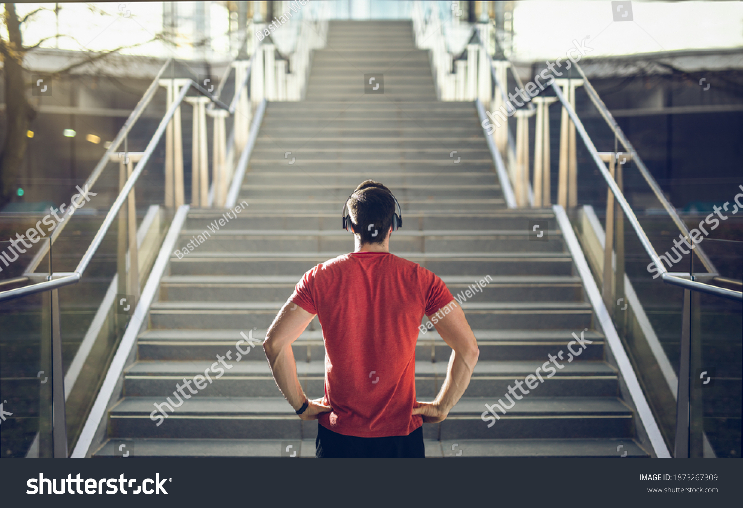 Man in red shirt preparing for stair run. #1873267309