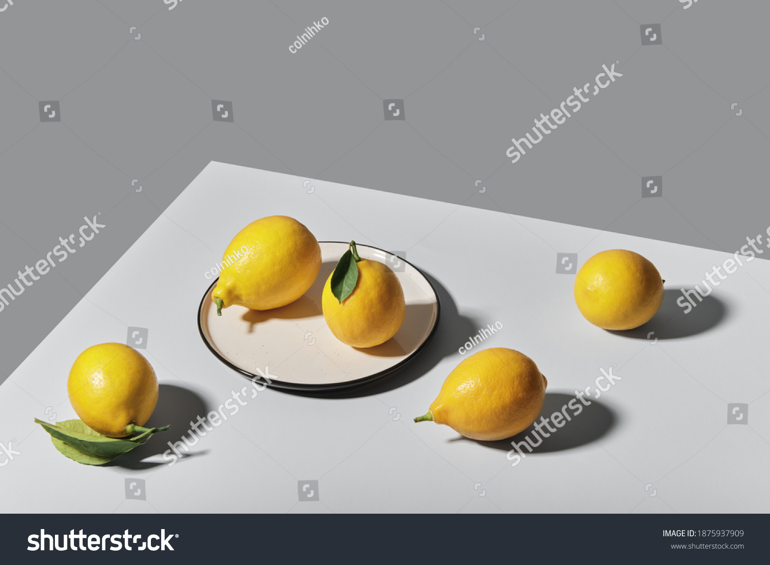 Trending colors of 2021. Yellow illuminating lemons on Ultimate gray tablecloth. Isometric view minimal still life. #1875937909