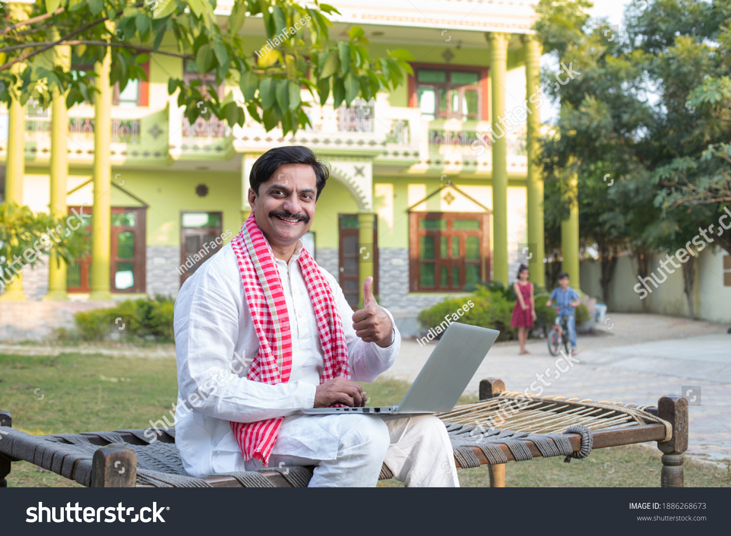 Indian rural farmer using laptop  #1886268673