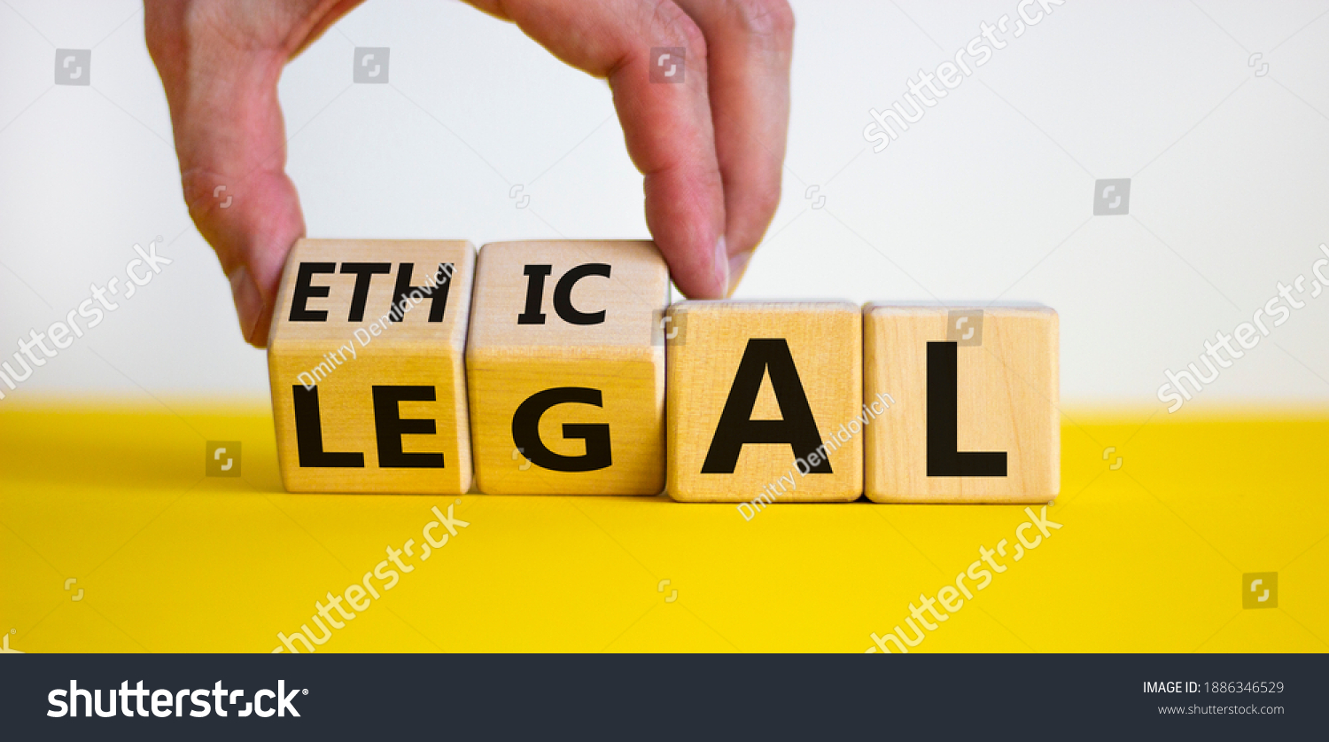 Ethical or legal symbol. Businessman hand turns wooden cubes and changes the word 'legal' to 'ethical' on a beautiful yellow table, white background. Business and ethical or legal concept. Copy space. #1886346529