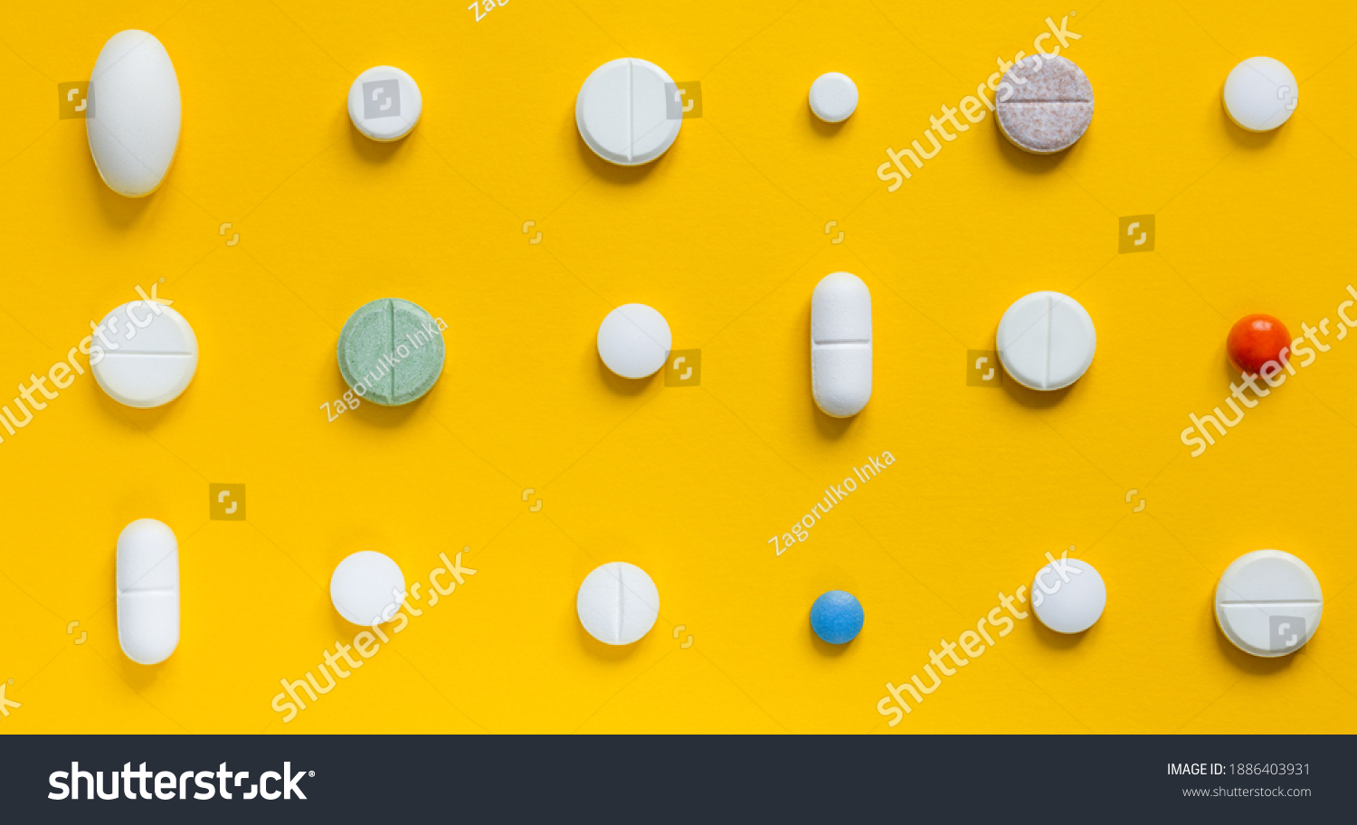 Medical white pills on a yellow background. Pharmaceutical concept #1886403931