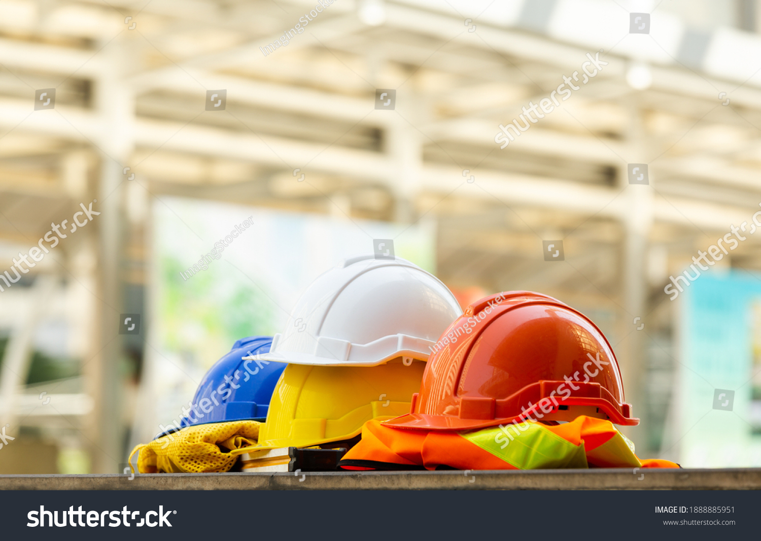 Close up Blue, yellow, white and red hard safety helmet hats for safety project of workman as engineering or project worker place on concrete floor city outdoor. #1888885951