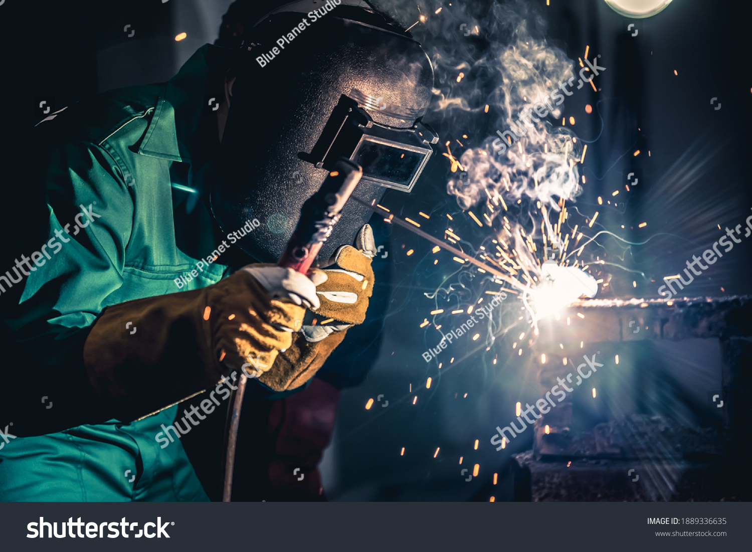 Metal welding steel works using electric arc welding machine to weld steel at factory. Metalwork manufacturing and construction maintenance service by manual skill labor concept. #1889336635