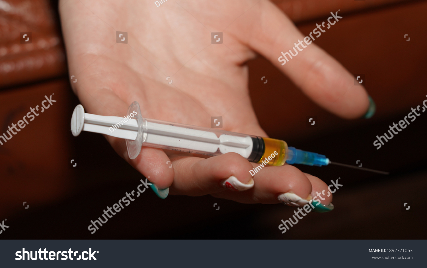 
Syringe in a woman's hand #1892371063