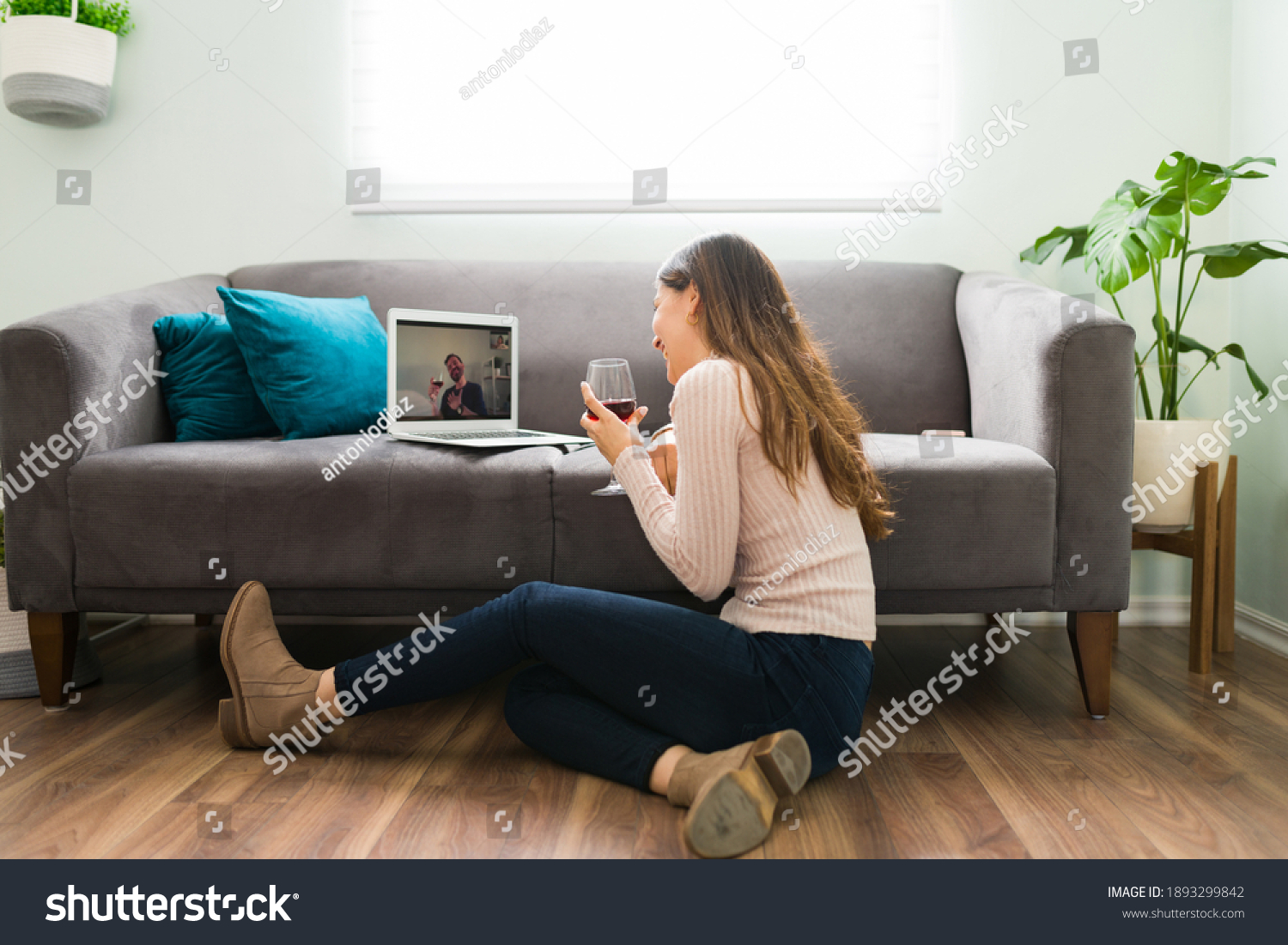 Good looking couple in a long-distance relationship is laughing and having a good time during a romatic online date  #1893299842