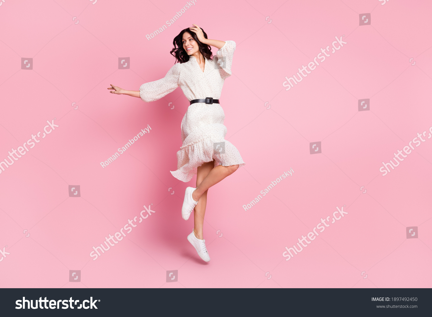 Full length body size photo of cheerful woman in long dress jumping looking empty space isolated pastel pink color background #1897492450