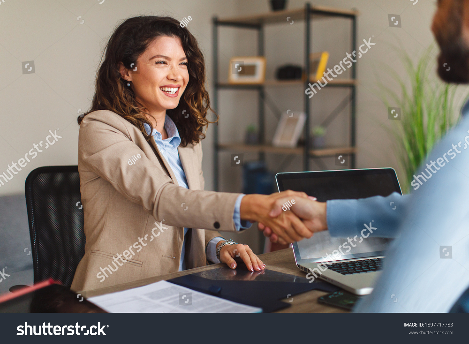 Young woman signing contracts and handshake with a manager #1897717783