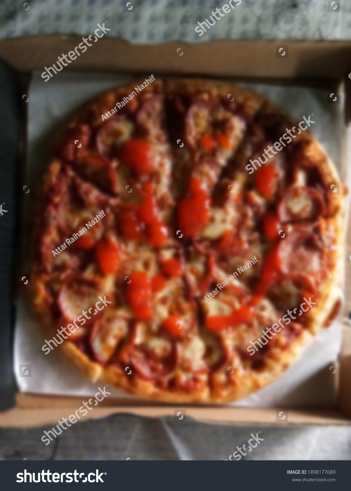 A blurred image of a pepperoni pizza #1898177689