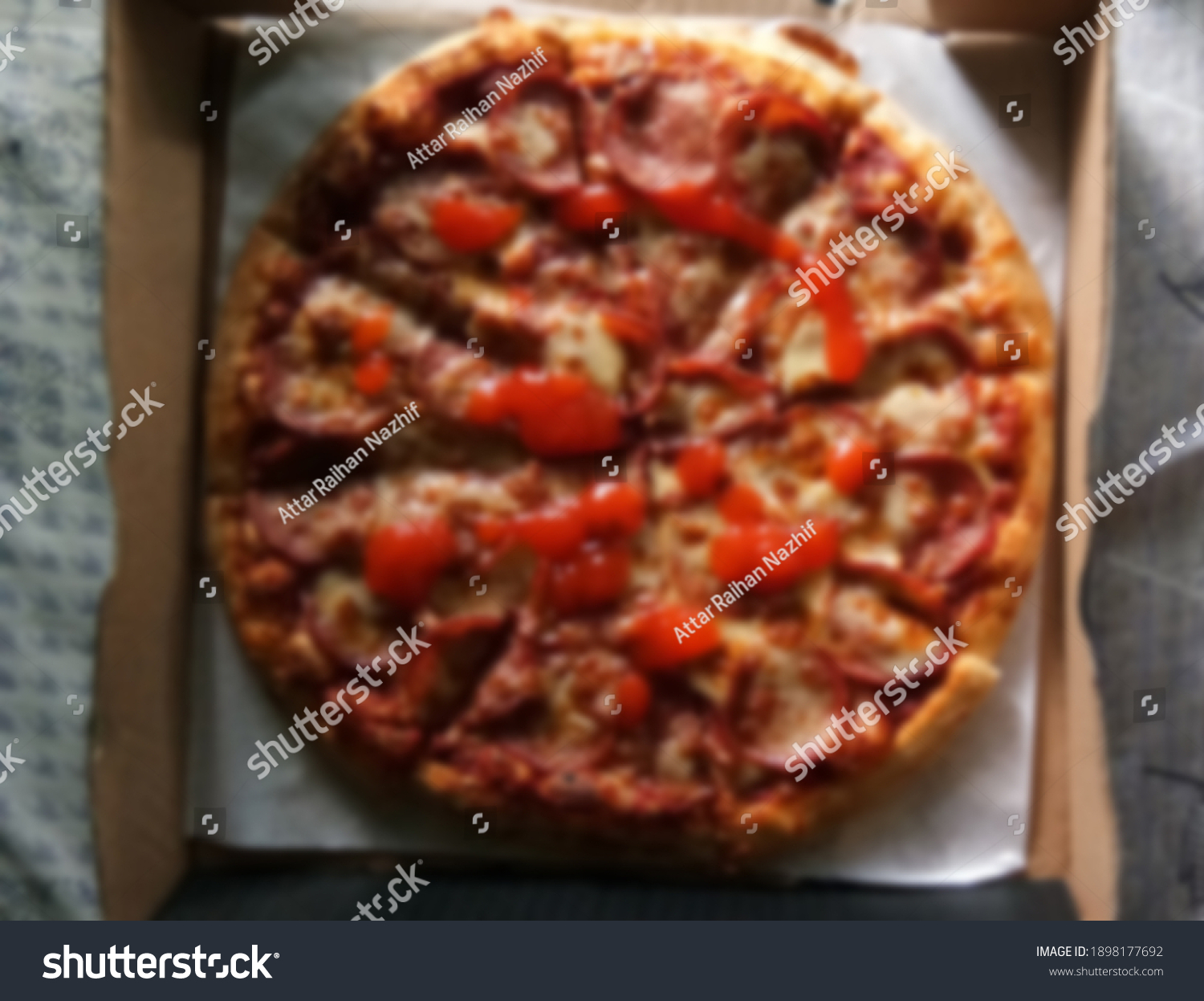 A blurred image of a pepperoni pizza #1898177692
