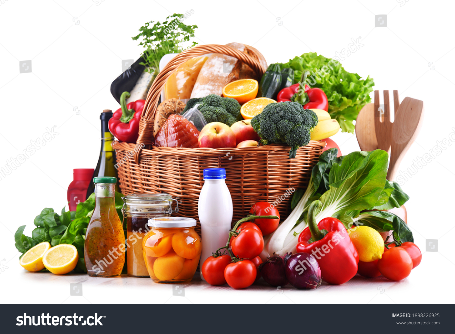 Wicker basket with assorted grocery products including fresh vegetables and fruits #1898226925