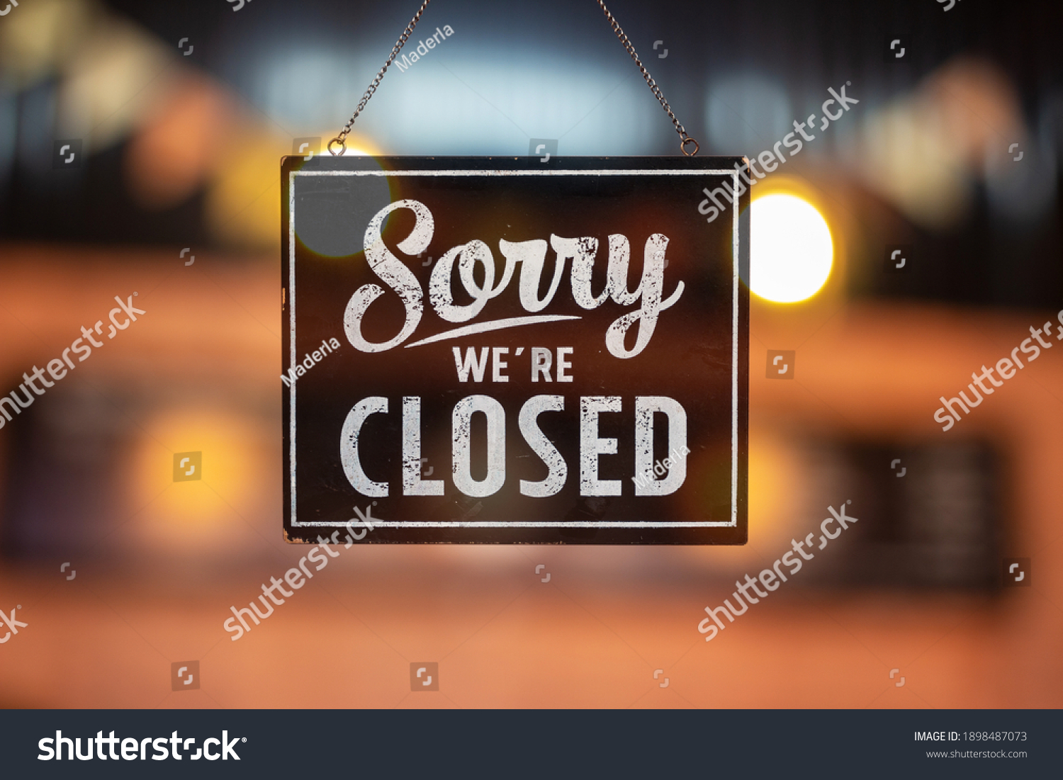 Sorry we're closed sign. grunge image hanging on a glass door. #1898487073