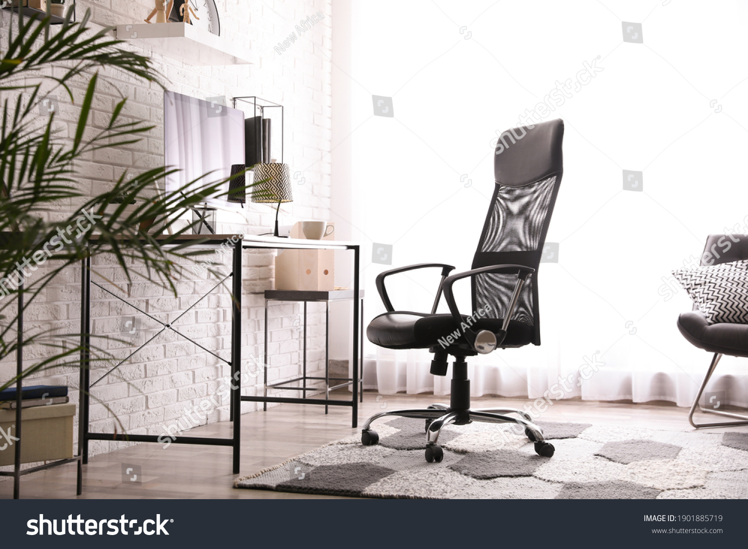 Comfortable chair near desk in modern office interior #1901885719