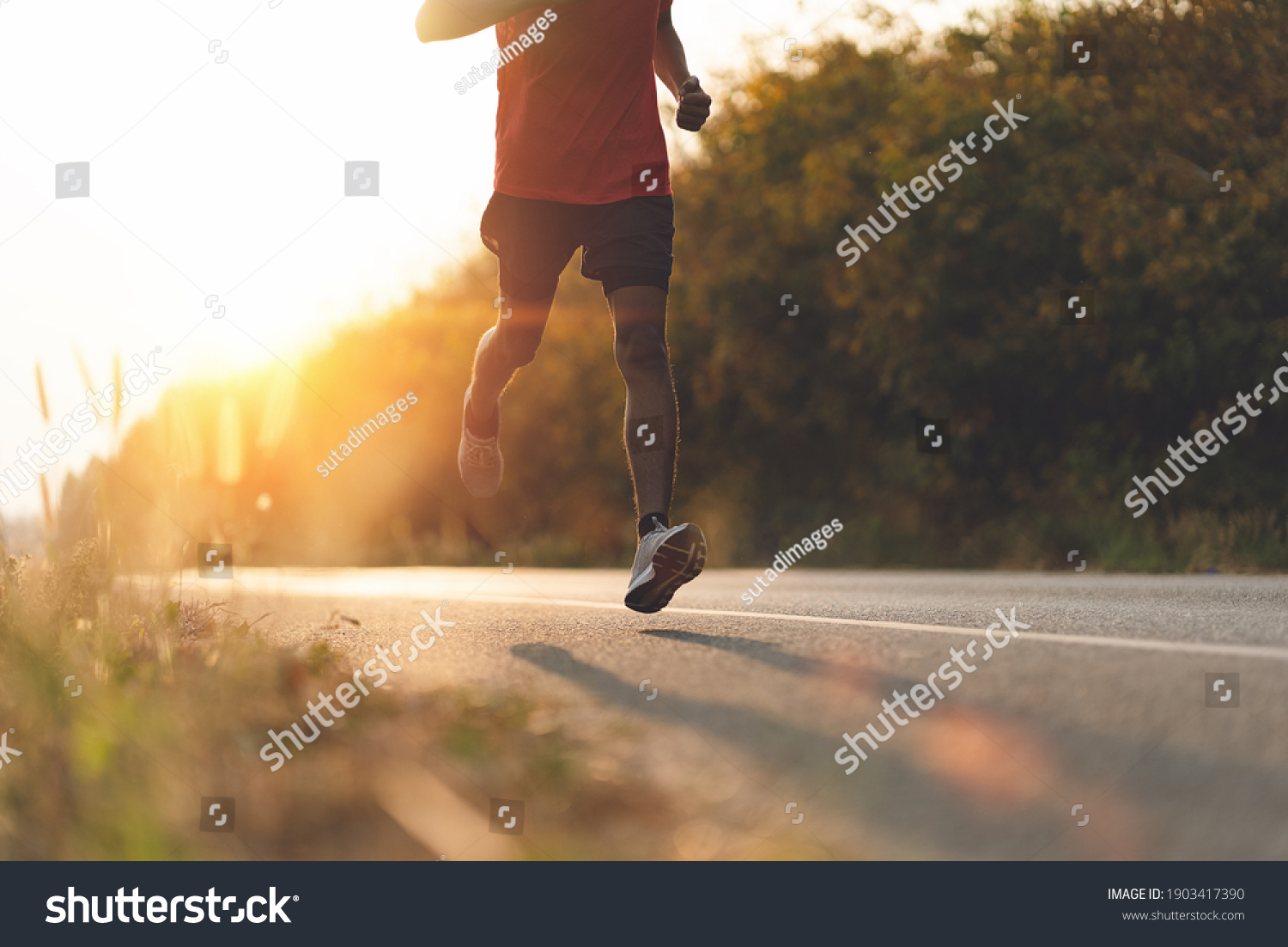 Athlete runner feet running on road, Jogging concept at outdoors. Man running for exercise. #1903417390