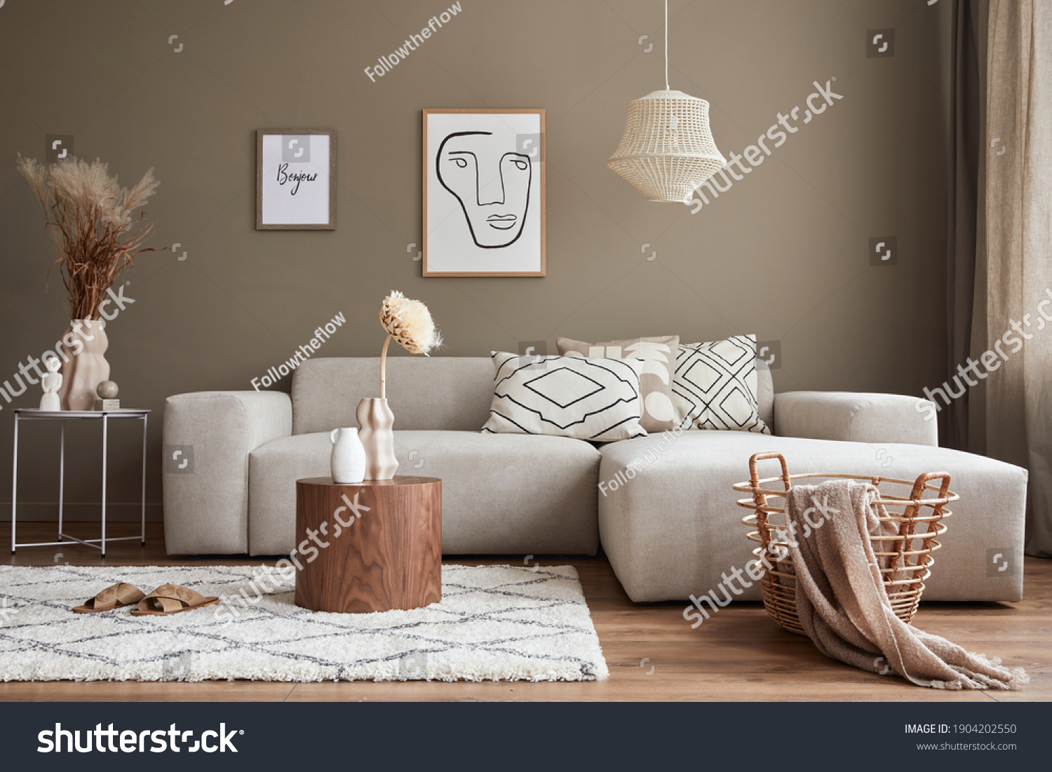 Interior design of stylish living room with modern neutral sofa, mock up poster farmes, dried flowers in vase, coffee tables, decoration and elegant personal accessories in home decor. Template. #1904202550