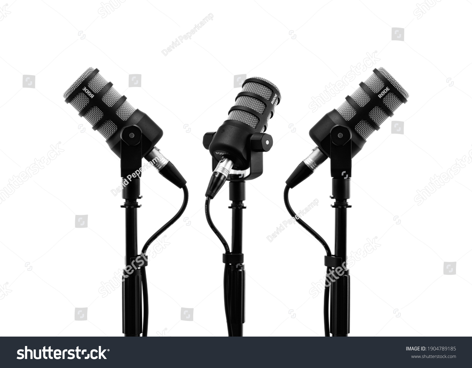 Three podcast microphones on a tripod, a black metal dynamic microphone on an isolated white background, for recording podcast or radio program, show, sound and audio equipment, technology, Photo, DJ #1904789185