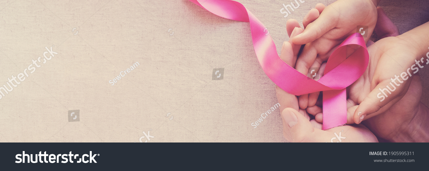 Adult and child hands holding pink ribbons, Breast cancer awareness,  October Pink , world cancer day #1905995311