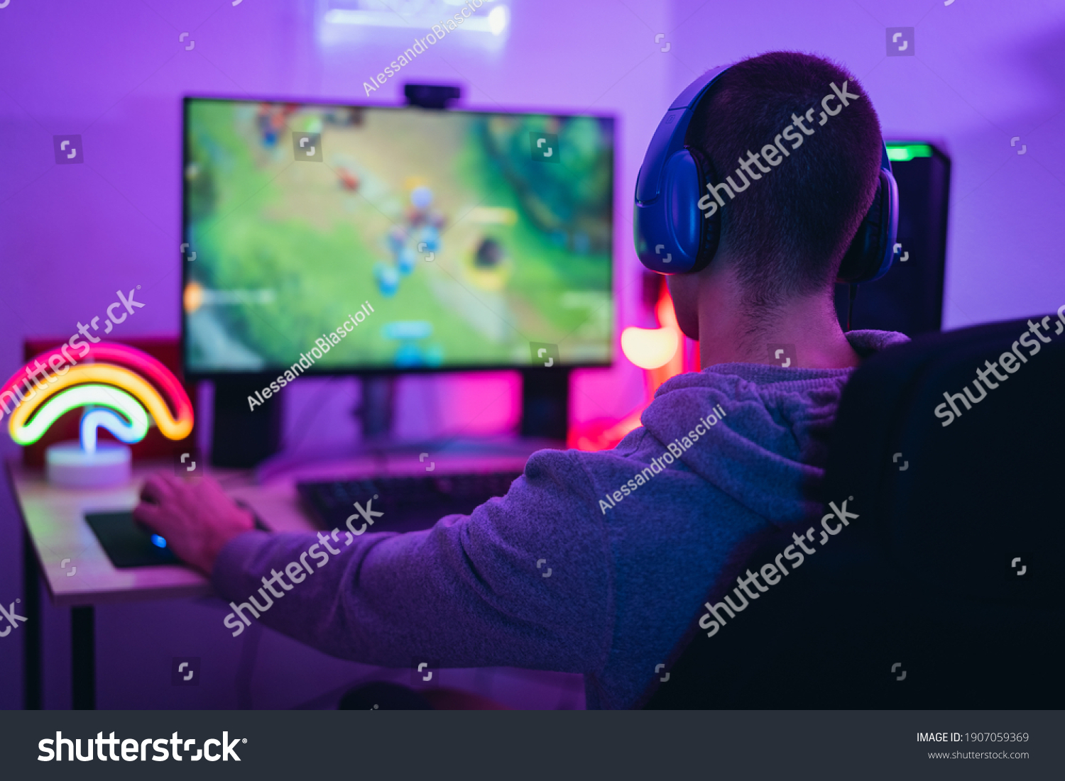 Young gamer playing online video games while streaming on social media - Youth people addicted to new technology game #1907059369