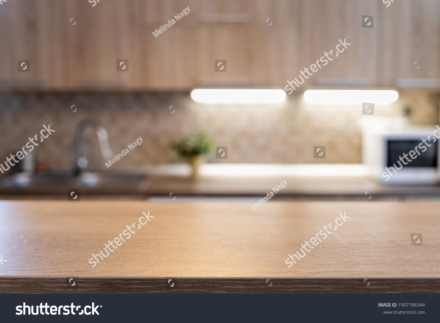 blurred kitchen interior and wooden desk space home background #1907186344