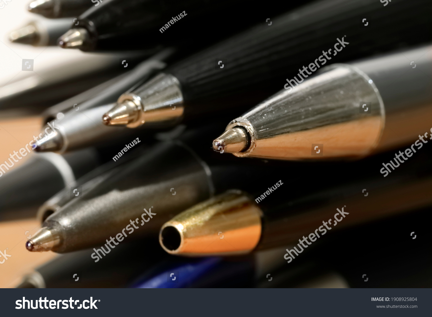 Some miscellaneous used ball pens in a pile. Office accessories. #1908925804