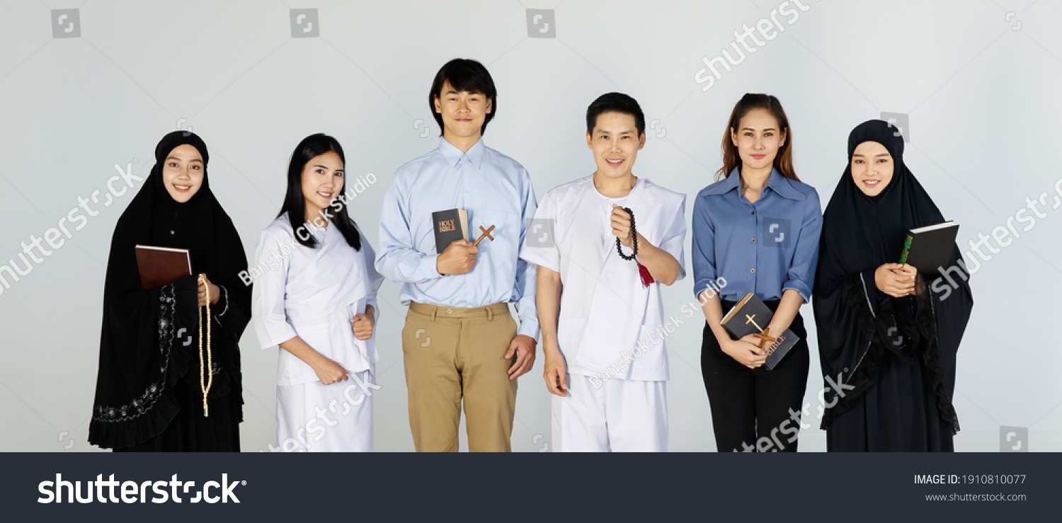 Asian men and women of different religions have Buddhism, Muslims, Christ bible Quran. A smiling face wearing religious clothes, white background. Concept religions exchange teachings with one another #1910810077