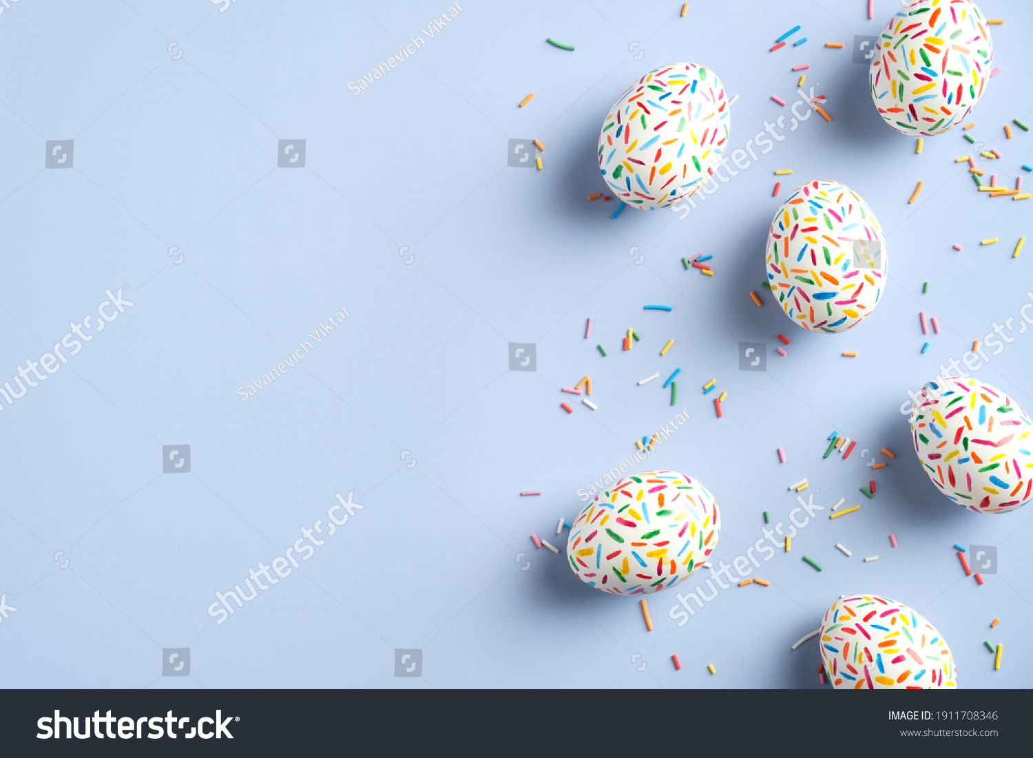 Creative layout with colorful Easter eggs on blue background. Happy Easter banner mockup. Minimal style. Flat lay, top view. #1911708346