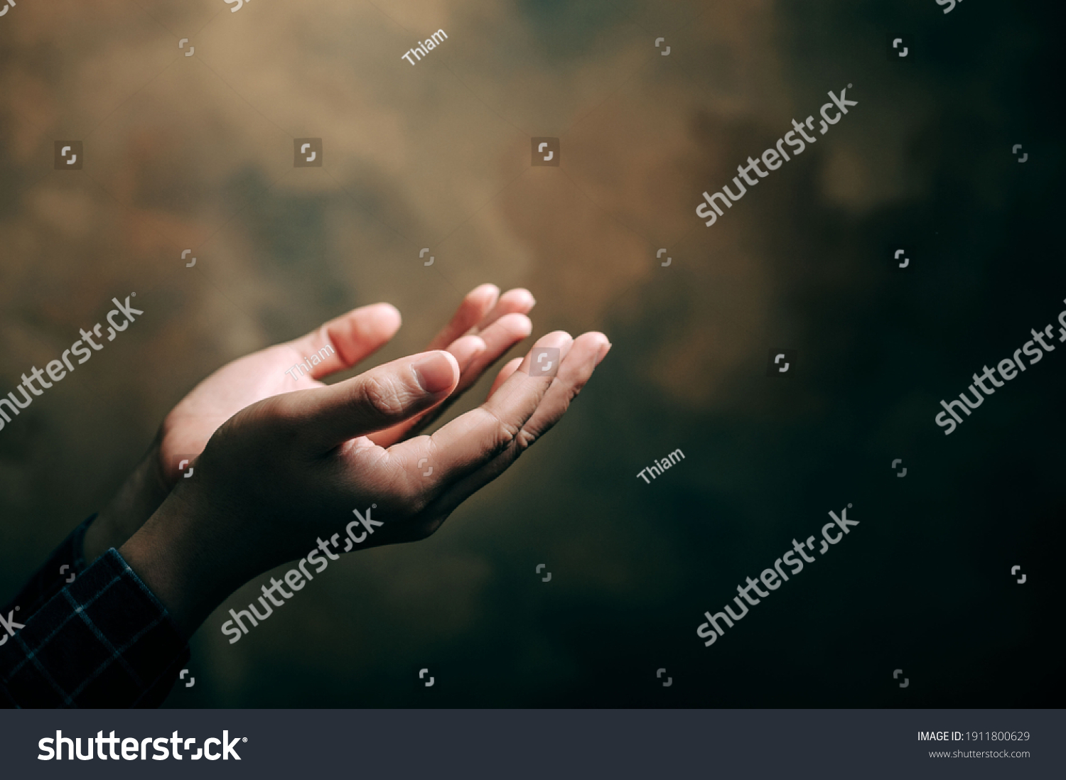 praying hands with faith in religion and belief in God on blessing background. Power of hope or love and devotion. #1911800629
