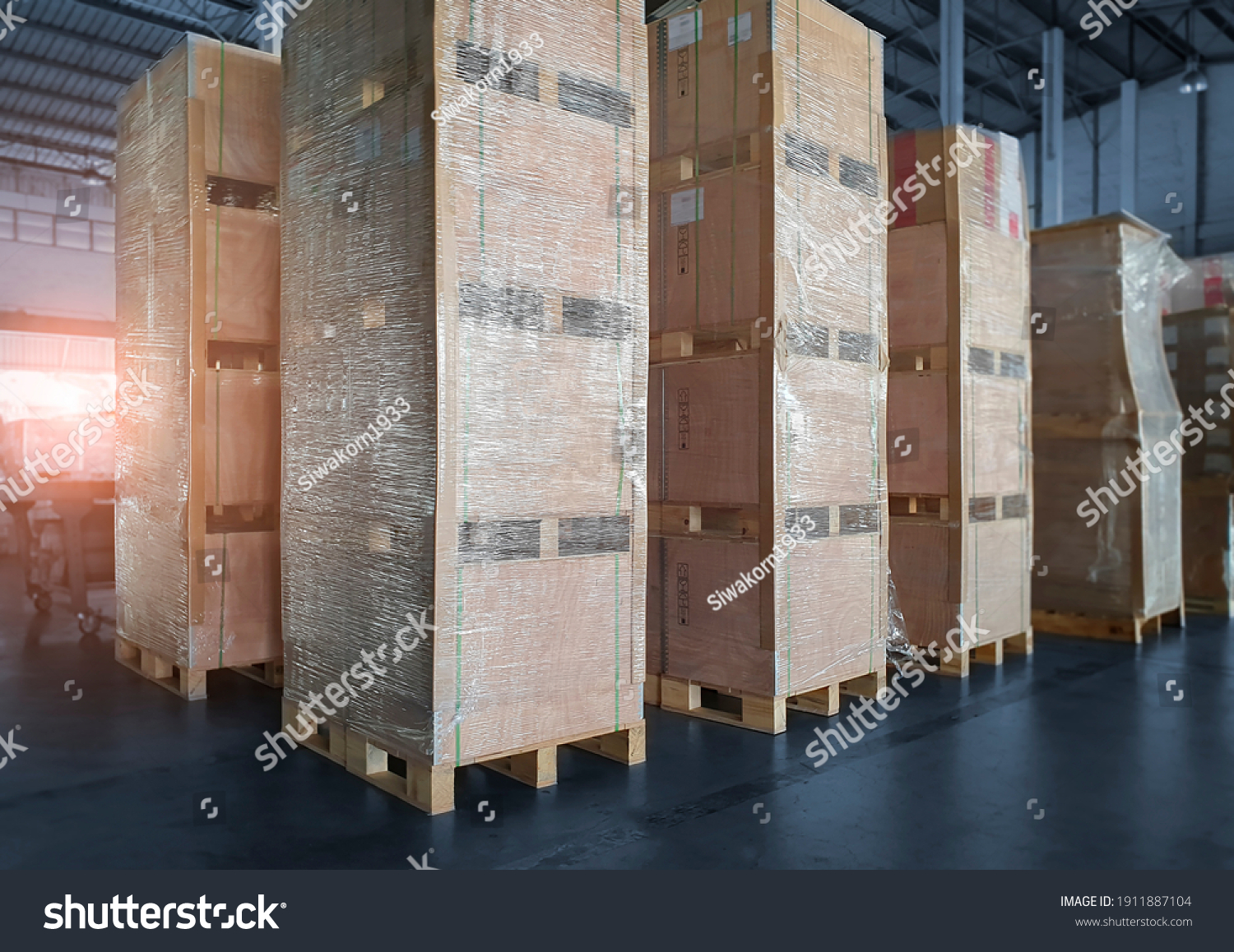 Interior of storage warehouse with stack wooden crates wrapped plastic. L-shape pallet corrugated paper cardboard Angle corner edge protector. shipping warehouse. cargo export  import. #1911887104