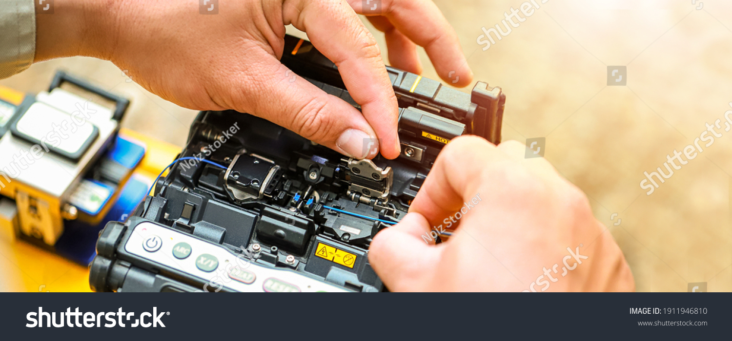 Banner template Technician Fiberoptic Fusion Splicing. Worker connecting for Cable Internet signal and Wire connection with Fiber Optic Fusion Splicing machine,fiber optic cable splice machine in work #1911946810