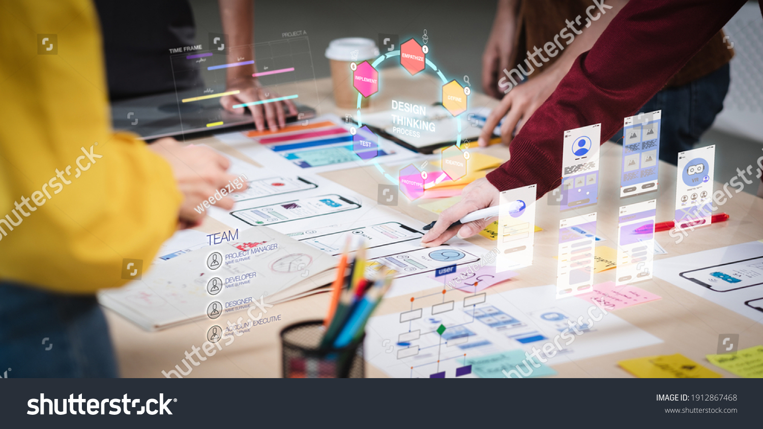 Close up ux developer and ui designer use augmented reality brainstorming about mobile app interface wireframe design on desk at modern office.Creative digital development agency #1912867468