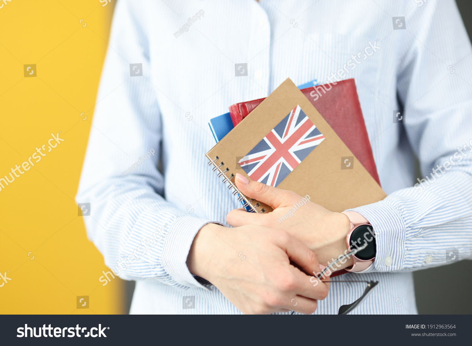 Female silhouette holding diaries with British flag. Self-study foreign languages concept #1912963564