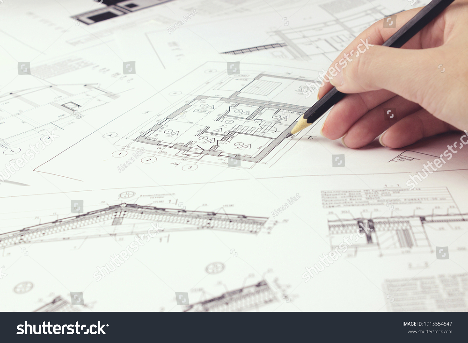 An architect engineer creates a working drawing sketch for building a house building. Architectural design projects concept. Engineering and architecture drawings #1915554547