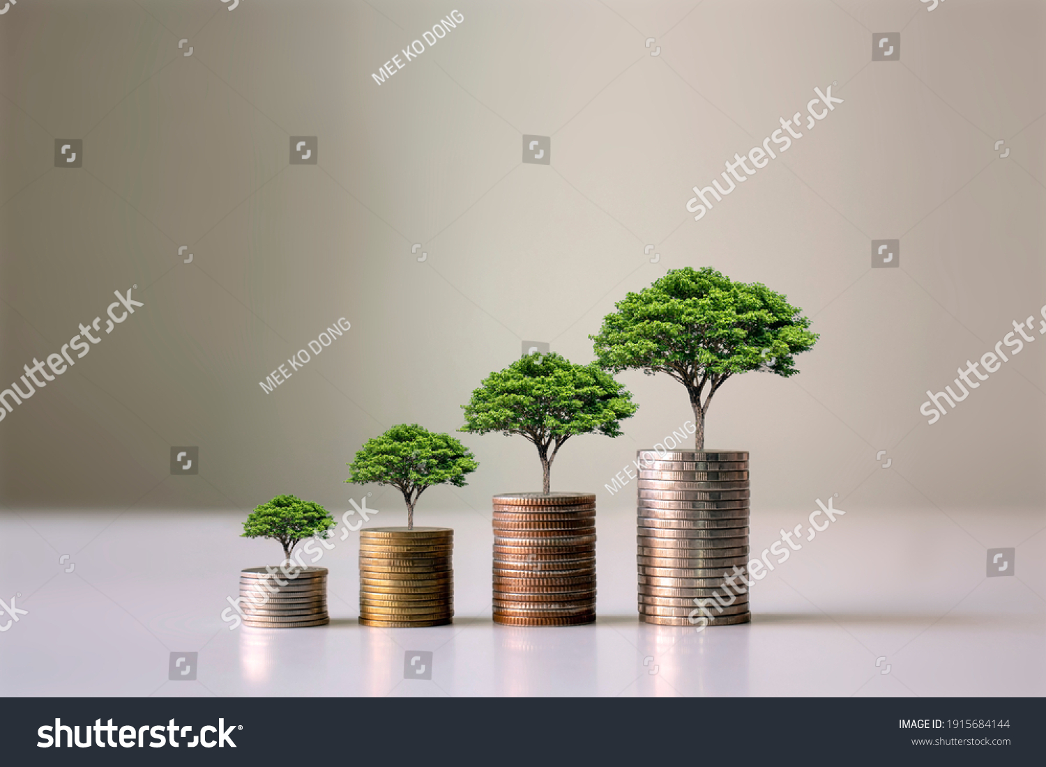 Showing financial developments and business growth with a growing tree on a coin. #1915684144