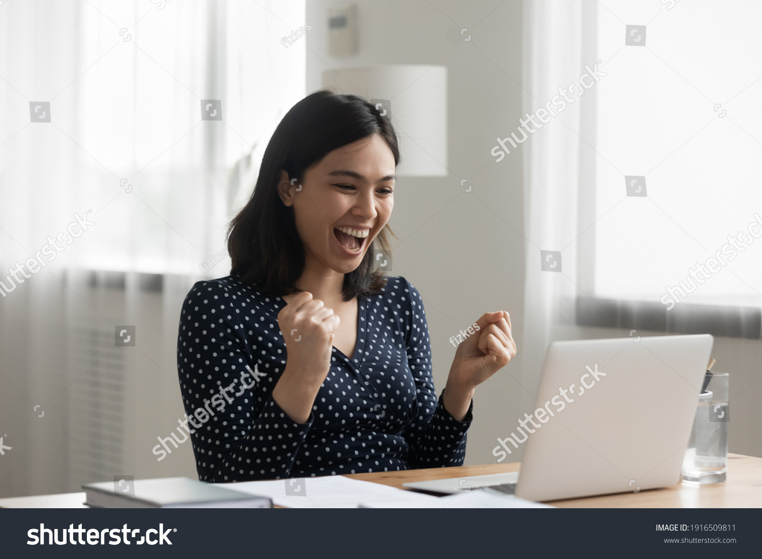 Excited young vietnamese woman look at laptop pc screen in delight receiving good news being accepted admitted to college university. Overjoyed asian lady office worker get reward promotion by email #1916509811