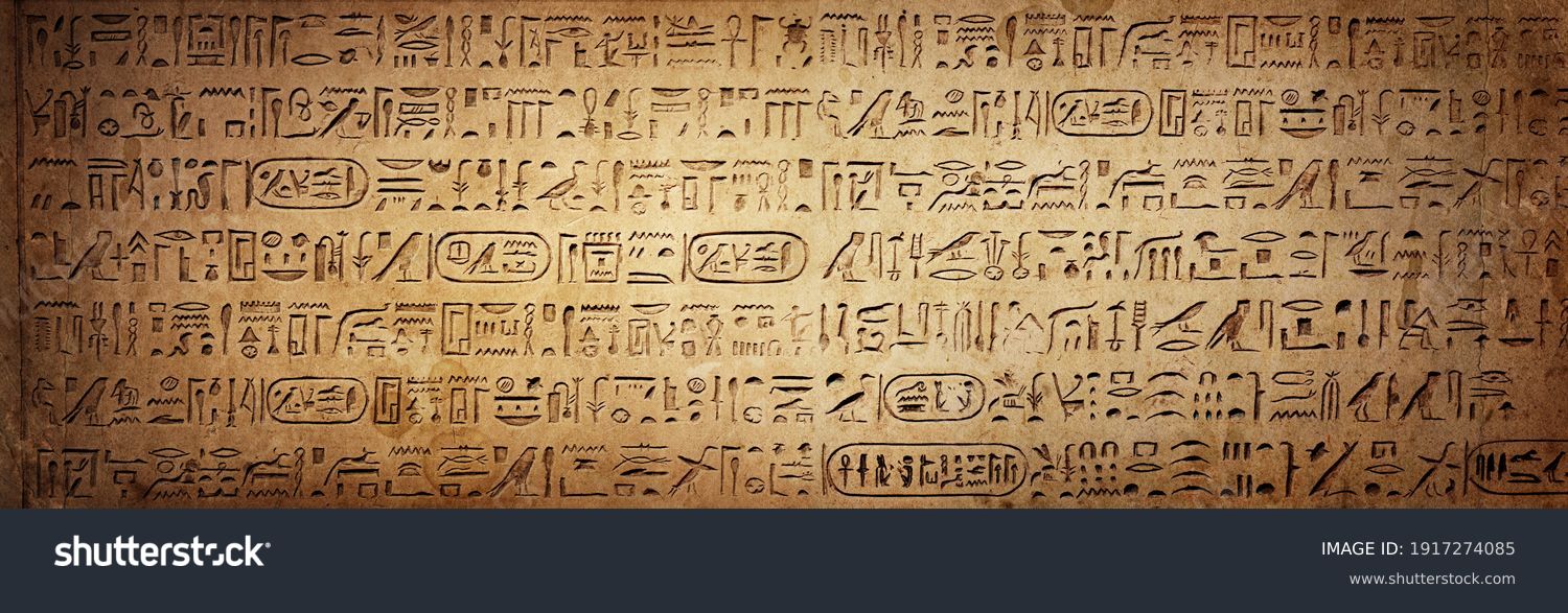 Old Egyptian hieroglyphs on an ancient background. Wide historical background. Ancient Egyptian hieroglyphs as a symbol of the history of the Earth.  #1917274085