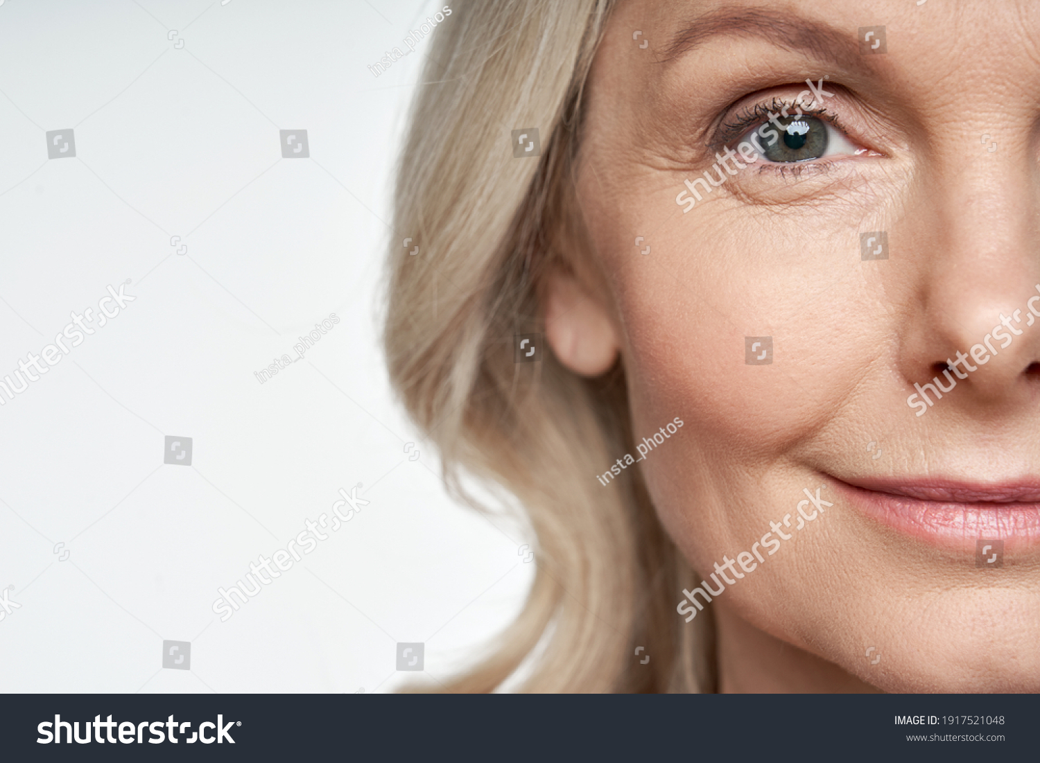 50s middle aged old woman looking at camera isolated on white background advertising dry skin care treatment anti age skincare beauty, plastic surgery, cosmetology procedures. Close up half face view #1917521048