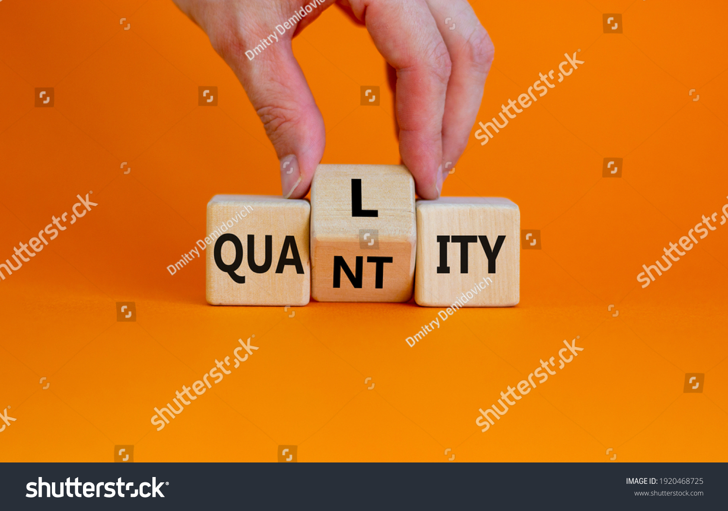 Quality over quantity symbol. Businessman turns cubes and changes the word 'quantity' to 'quality'. Beautiful orange table, orange background, copy space. Business and quality over quantity concept. #1920468725