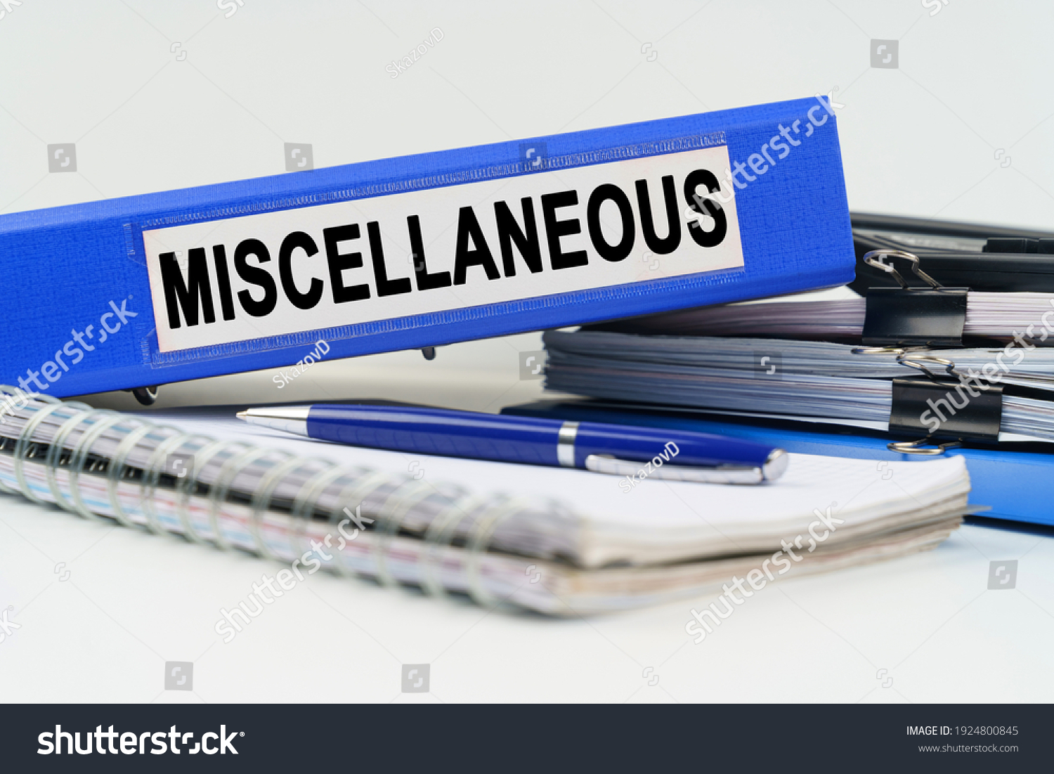 Business and finance concept. On the table are a notebook, a pen, documents and a folder with the inscription - MISCELLANEOUS #1924800845