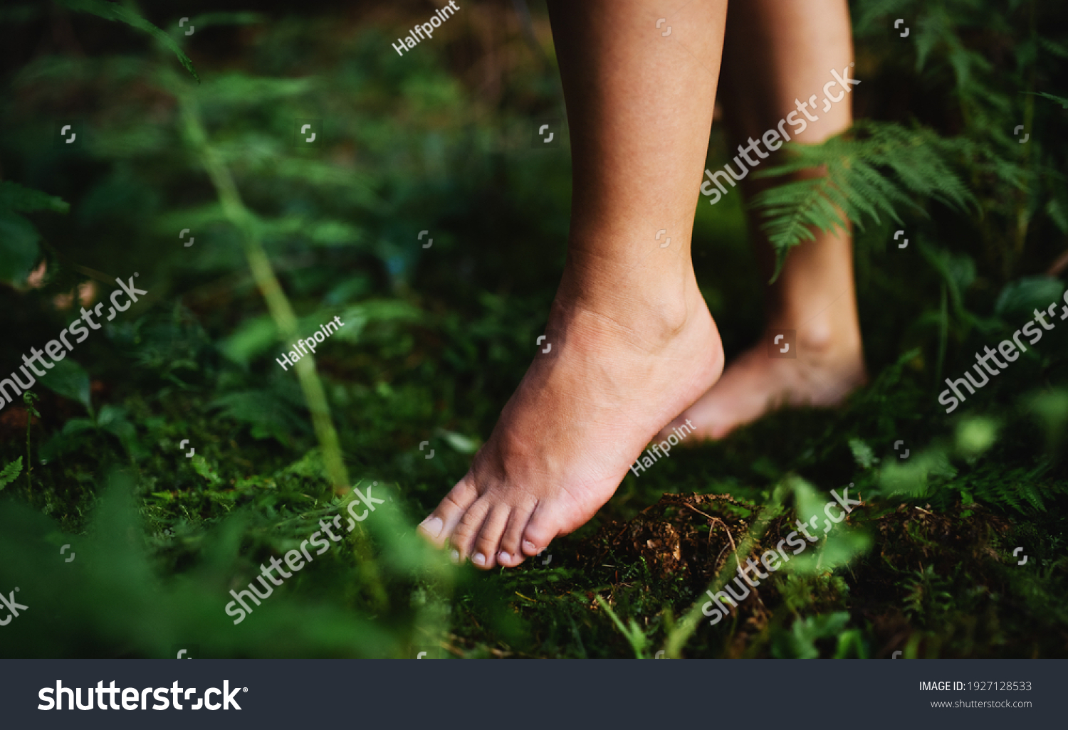 Bare feet of woman standing barefoot outdoors in nature, grounding concept. #1927128533