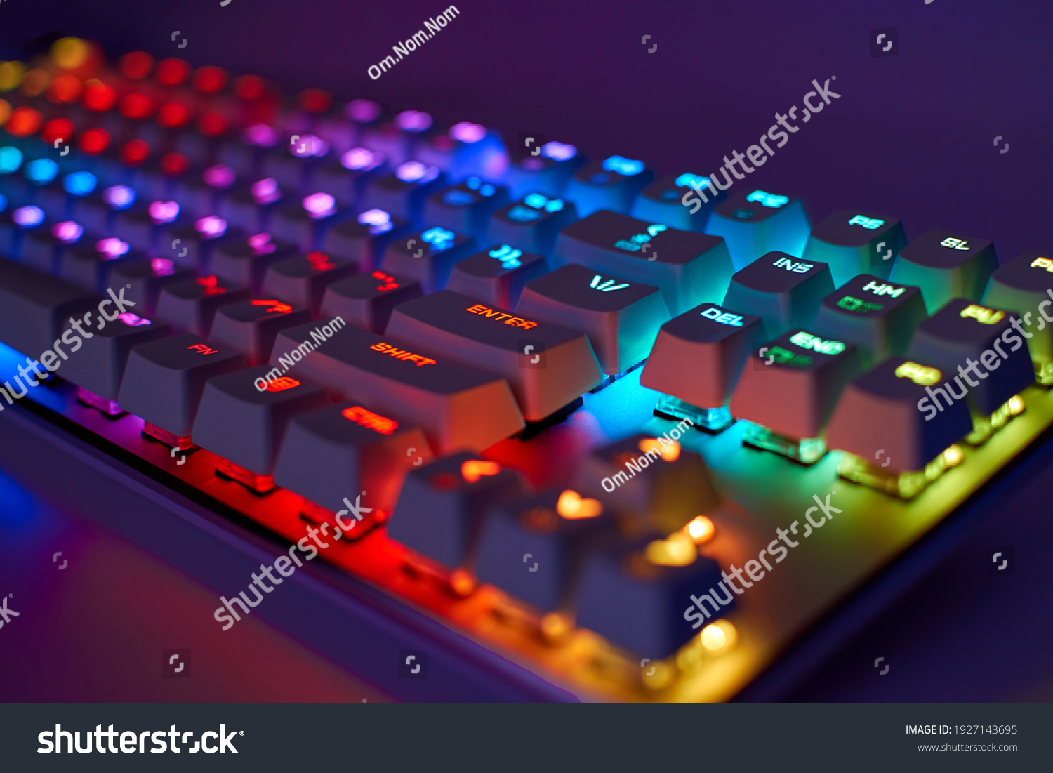 RGB gaming keyboard. Bright colorful keyboard, soft focus. Mechanical keyboard with RGB light, blurred background. #1927143695