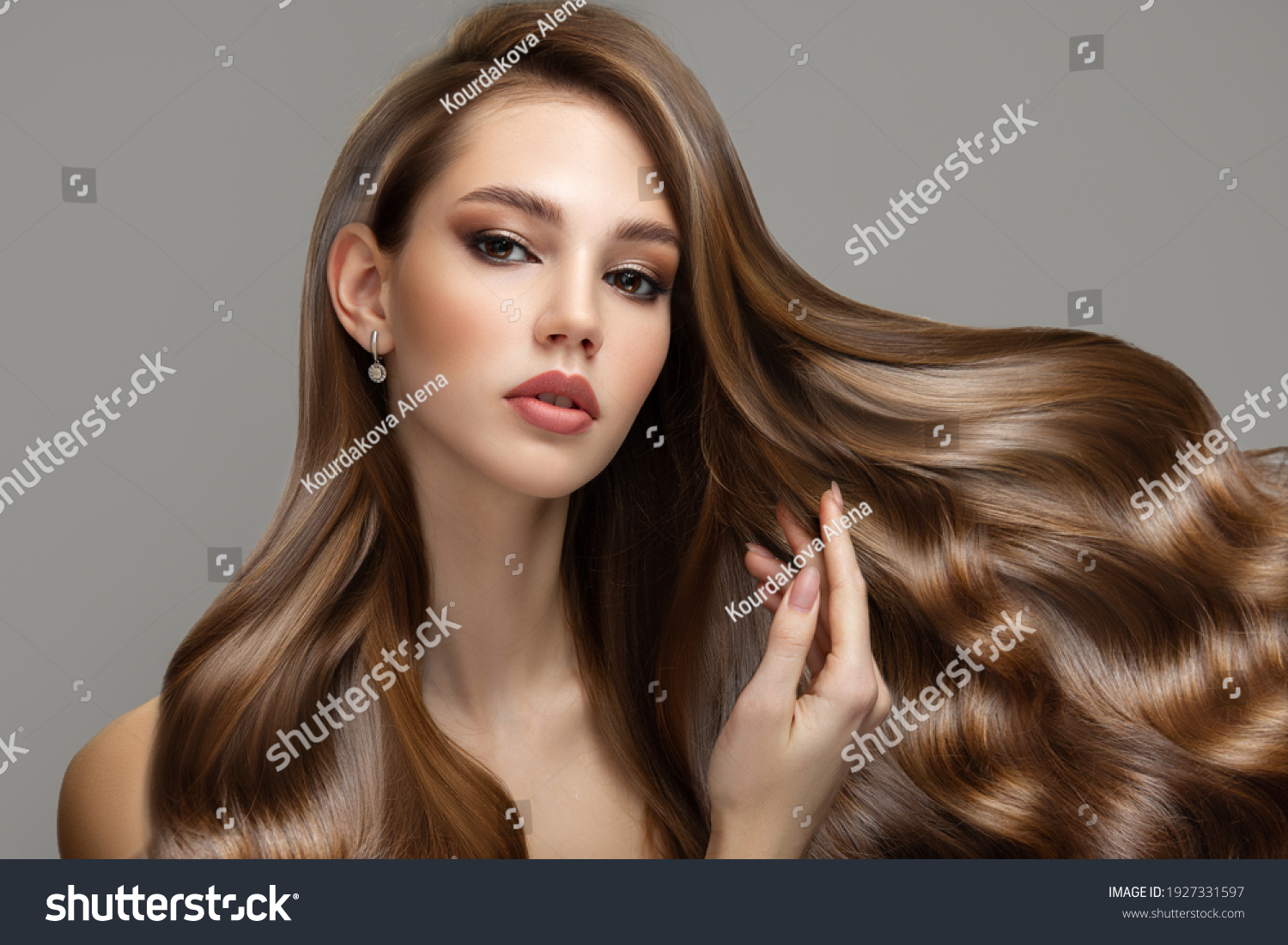 Portrait of a beautiful brunette woman with long wavy hair. Copycpase #1927331597