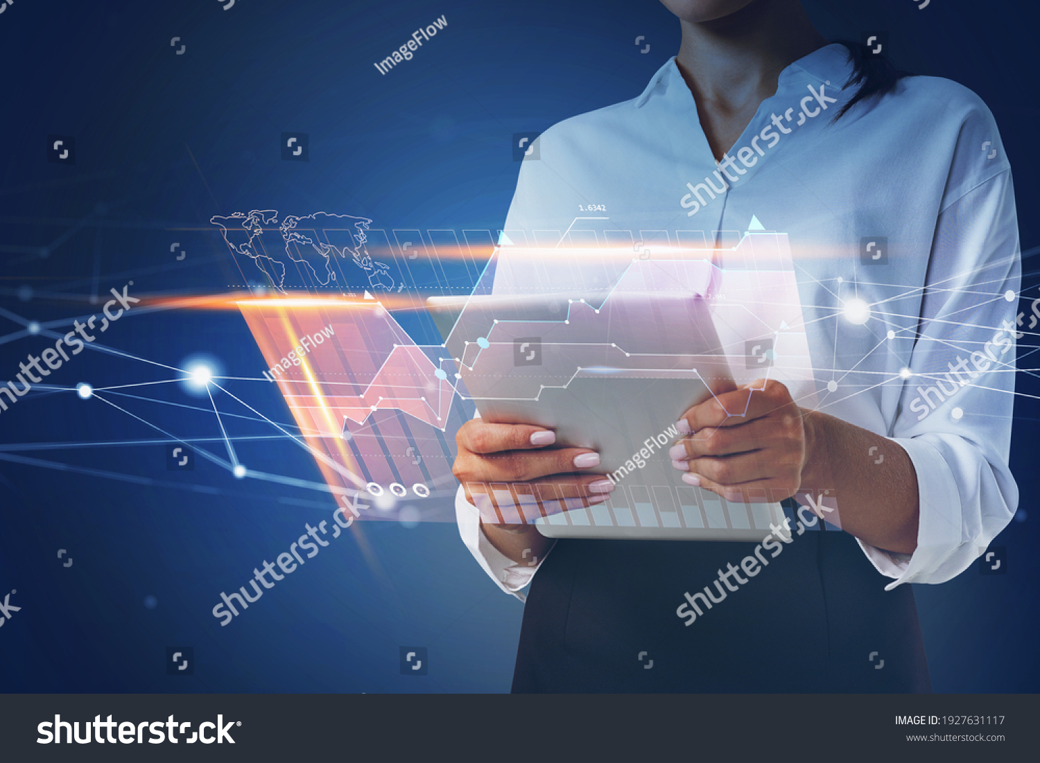 Businesswoman holding tablet and using technological approach to optimize business process. System hologram charts and graph flying nearby smartphone. Office on background. #1927631117
